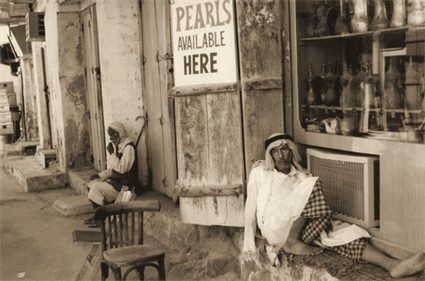 A shop with a sign reading Pearls Available Here, Dubai, 1962
